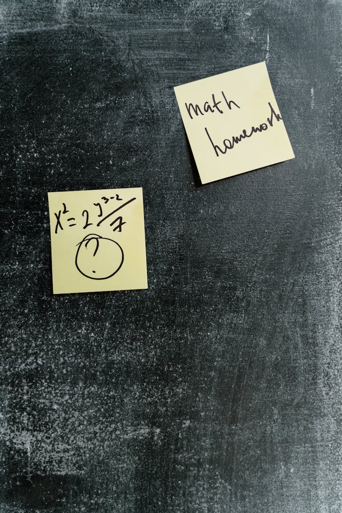 story-01 Sticky notes with math equations and homework reminders on a chalkboard.